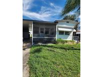 Mobile home exterior features carport and screened porch at 519 51St Avenue W Ter, Bradenton, FL 34207