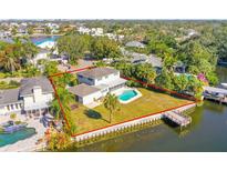 Aerial view of a waterfront home with a pool and dock at 5108 W San Jose St, Tampa, FL 33629