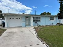 Charming single-story home with a well-manicured lawn, garage, and inviting front entrance at 10170 64Th Ave, Seminole, FL 33772