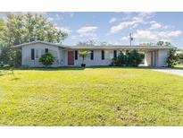 Ranch style home with carport and spacious lawn at 2618 Nassau St, Sarasota, FL 34231