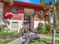 Exterior view of condo building with landscaping and walkway at 3869 S Lake Dr # 146, Tampa, FL 33614