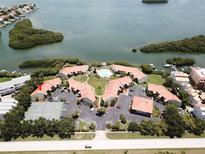 Aerial view of waterfront community with pool, tennis courts, and parking at 1515 Pinellas Bayway S # 45, St Petersburg, FL 33715
