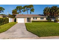 Front view of a single-story house with a neat lawn and attached garage at 4510 Helena Ne St, St Petersburg, FL 33703