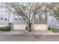 Modern two-story townhome with attached garage and tree-lined street at 4522 Bay Spring Ct, Tampa, FL 33611