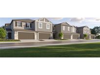 New townhouses with two-car garages and landscaping at 32084 Spiceberry St, San Antonio, FL 33576