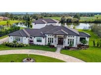 Luxury home with circular driveway, lake views, and meticulously landscaped grounds at 323 Hawk Talon Dr, Lithia, FL 33547