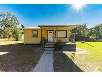 Front view of charming yellow house at 38032 Causey Rd, Dade City, FL 33523