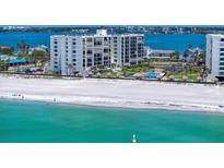 Beautiful aerial view of a beachfront condo with pool, sandy beach, and ocean views at 1400 Gulf Blvd # 801, Clearwater Beach, FL 33767