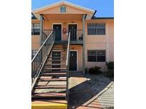 Exterior view of a two-story building with stairs and multiple entrances at 12404 Orange Blossom Oak Pl # 101, Tampa, FL 33612