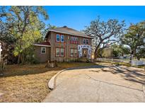 Two-story house with a large front yard and a long driveway at 1530 22Nd S Ave, St Petersburg, FL 33705