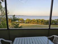 Relax on the screened balcony, boasting panoramic views of the tranquil bay waters and lush green landscape at 2617 Cove Cay Dr # 505, Clearwater, FL 33760