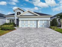 Stunning two-story home with three-car garage and a paved driveway at 34 Concord Dr, Dunedin, FL 34698