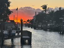 Stunning sunset over the canal, with boats and waterfront homes at 4921 W San Rafael St, Tampa, FL 33629