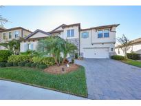 Two-story house with stone accents, a three-car garage, and lush landscaping at 12609 Pensacola Ct, Riverview, FL 33579