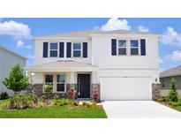 Charming two-story home with blue shutters, stone accents, and a well-manicured lawn at 16033 7Th E Ave, Bradenton, FL 34212