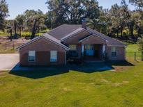 Brick house with large yard and driveway, seen from above at 1827 Joe Mcintosh Rd, Plant City, FL 33565