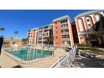 Community pool with surrounding patio and building view at 6960 20Th N Ave # 501, St Petersburg, FL 33710