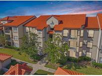 Attractive condo building with Spanish-style architecture and tiled roofs at 18106 Peregrines Perch Pl # 5204, Lutz, FL 33558