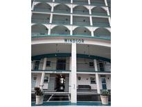 Windsor building exterior, featuring multiple balconies and a covered entrance at 6020 Shore S Blvd # 301, Gulfport, FL 33707