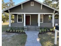 Charming bungalow with gray exterior, front porch, and landscaped walkway at 1221 E Curtis St, Tampa, FL 33603