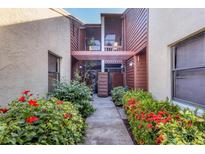 Shared condo entry with lush landscaping and a walkway leading to the building entrance at 4542 Park Lake N Ter # 4542, Bradenton, FL 34209