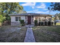 Inviting house exterior featuring stone accents and a landscaped lawn at 702 W Cherry St, Plant City, FL 33563