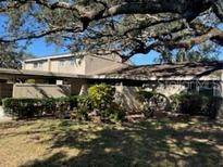 Exterior view of condo with mature landscaping at 8631 Cattail Dr # 146, Temple Terrace, FL 33637