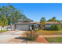 Charming single-story home with a well-maintained lawn and driveway at 12352 Monarch Cir, Seminole, FL 33772