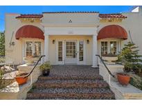 Spanish style home with terracotta roof, columns and awning at 334 Bay St, Tarpon Springs, FL 34689