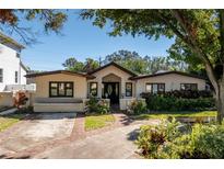 House exterior showcasing a charming curb appeal with well-maintained landscaping at 635 Hudson Ave, Tampa, FL 33606