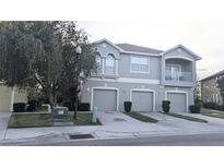 Two-story townhome with three-car garage and balcony at 9060 Moonlit Meadows Loop, Riverview, FL 33578
