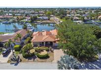 Waterfront home with lush landscaping, private dock, boat and beautiful terracotta roof at 1997 Kansas Ne Ave, St Petersburg, FL 33703