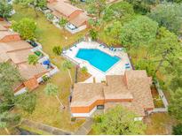 Aerial view of a townhome community showcasing a beautiful pool area at 2062 Sunset Point Rd # 65, Clearwater, FL 33765