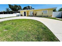 Charming single-story home with a well-manicured lawn and a curved driveway at 6366 38Th N Ave, St Petersburg, FL 33710