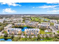 Aerial view of a condo community with a lake, golf course, and multiple buildings at 960 Starkey Rd # 5406, Largo, FL 33771