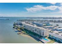 Stunning aerial view of waterfront condos with beautiful bay views and lush landscaping on a sunny day at 1847 Shore S Dr # 509, South Pasadena, FL 33707