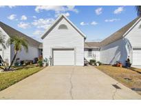 White exterior house with a garage and driveway at 206 Hidden Harbour Dr, Indian Rocks Beach, FL 33785