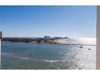 Aerial view of waterfront property, showcasing a luxurious high-rise building and stunning ocean views at 440 S Gulfview Blvd # 1705, Clearwater Beach, FL 33767