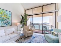 Bright living room with water views and comfortable seating at 440 S Gulfview Blvd # 1705, Clearwater Beach, FL 33767