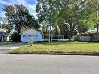 Ranch style home with a spacious front yard and attached garage at 621 Hudson Ave, Tampa, FL 33606