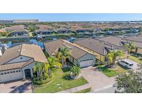 Stunning aerial view of a waterfront homes featuring lush landscaping and a private boat dock at 710 16Th E Ave, Palmetto, FL 34221