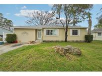 House exterior featuring a yellow house with a well-maintained lawn at 7201 Park S St, St Petersburg, FL 33707
