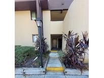 Exterior view showing building entrance with landscaping at 760 S Village N Dr # 103, St Petersburg, FL 33716