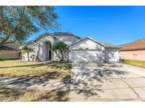 Spacious two-car garage, manicured lawn, and inviting curb appeal at 1326 Hatcher Loop Dr, Brandon, FL 33511