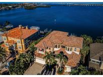 Breathtaking waterfront home featuring lush landscaping, a private dock, and stunning views at 308 Harbor Dr, Indian Rocks Beach, FL 33785