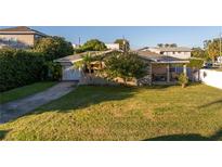 Charming single-story home featuring a lush green lawn and a welcoming front porch at 323 30Th N Ave, St Petersburg, FL 33704