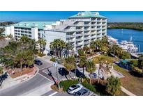 Aerial view of waterfront condo building with resort amenities and boat slips at 399 2Nd St # 718, Indian Rocks Beach, FL 33785