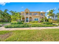 Mediterranean-style home featuring lush landscaping, a red tile roof, and a stately facade at 1925 Beach Se Dr, St Petersburg, FL 33705