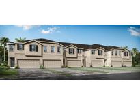 Tan three-story townhouses with garages and paver driveways at 31457 Woodland Race Loop, Wesley Chapel, FL 33545