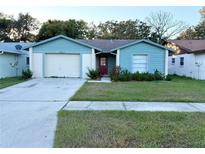 Ranch-style home with a one-car garage and well-maintained lawn at 1622 Palm Leaf Dr, Brandon, FL 33510